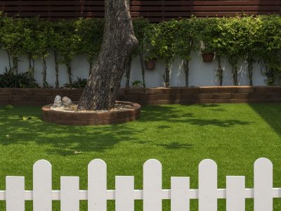 White fence around artificial grass lawn in Plano, Texas